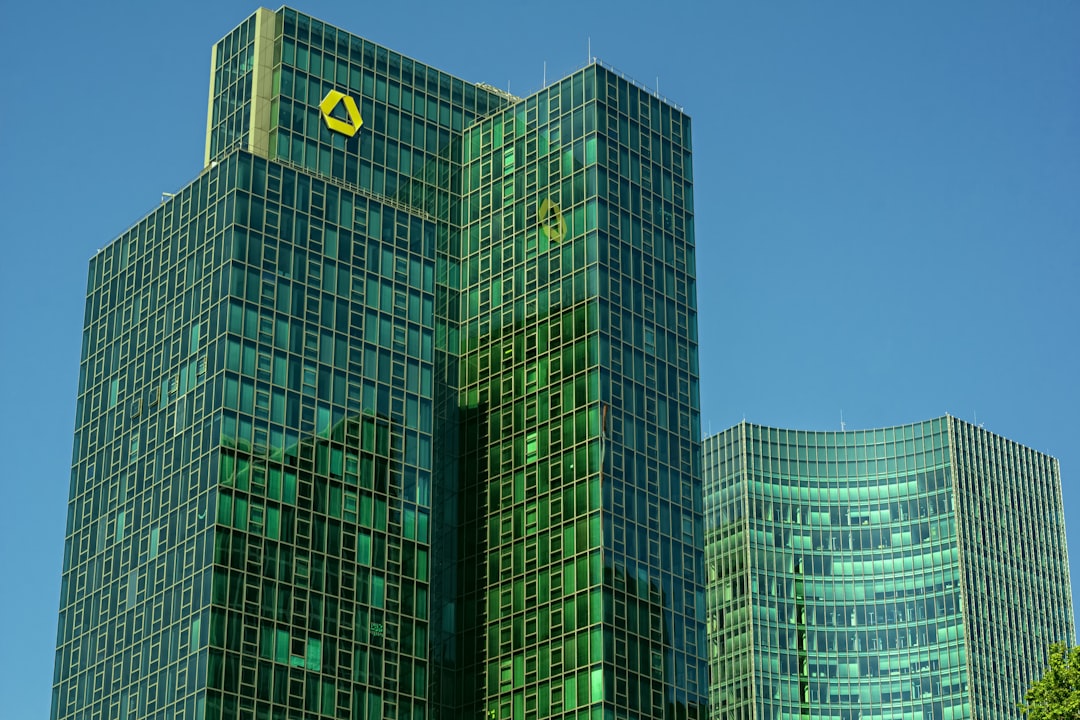 Modern skyscrapers rise against a blue sky.