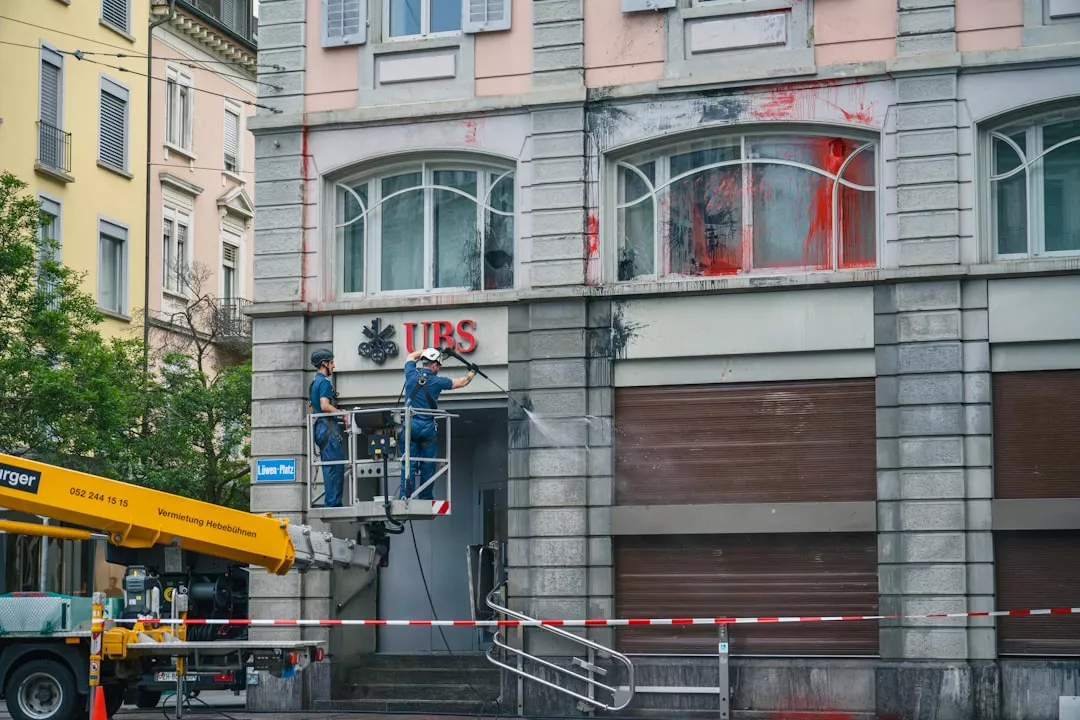 a man standing on a lift in front of a building