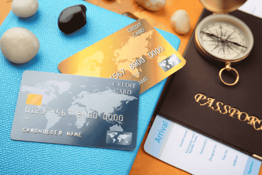 Travel essentials including passport, boarding pass, and two credit cards